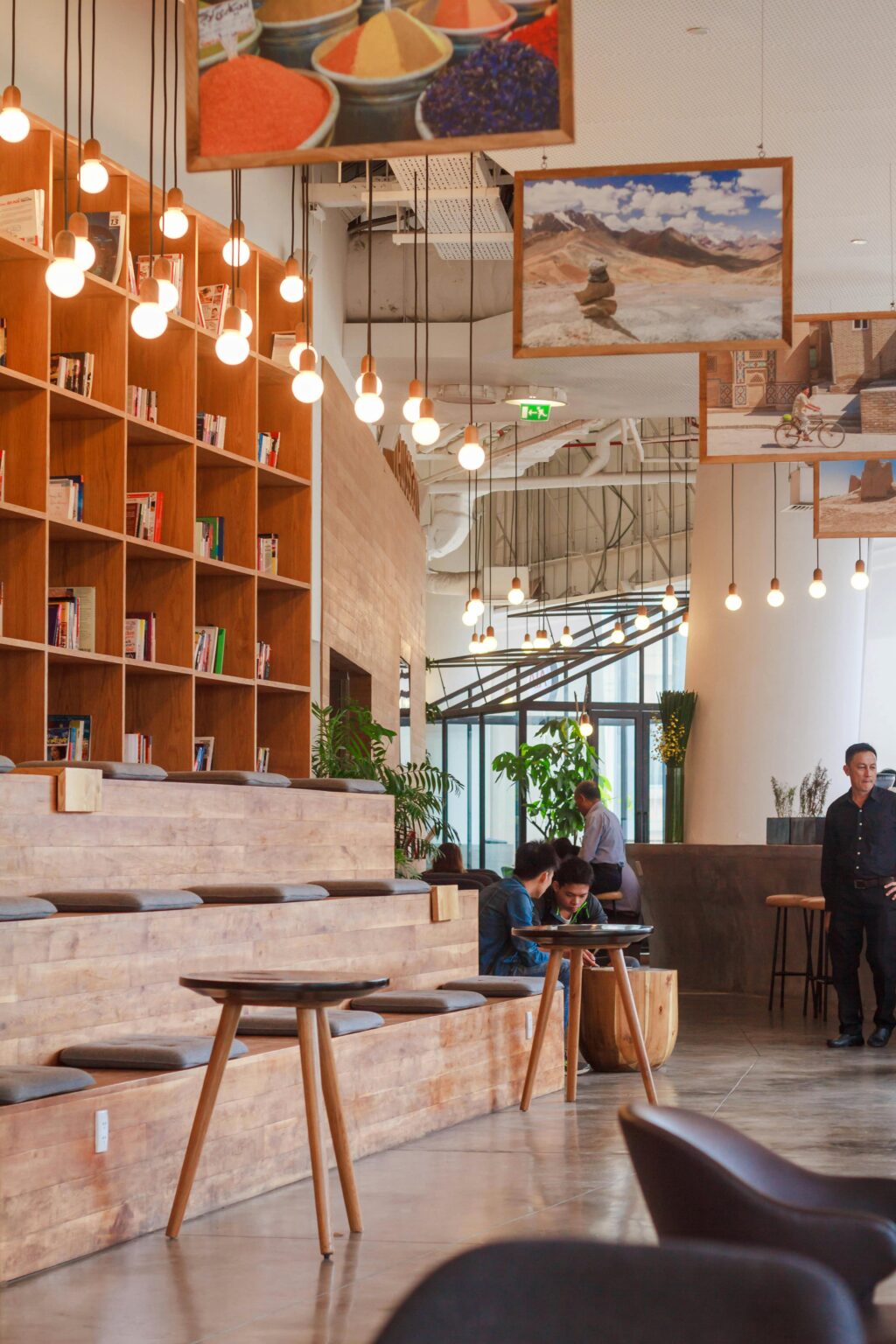 Elegant modern workspace in Ho Chi Minh City with bookshelves and pendant lighting.